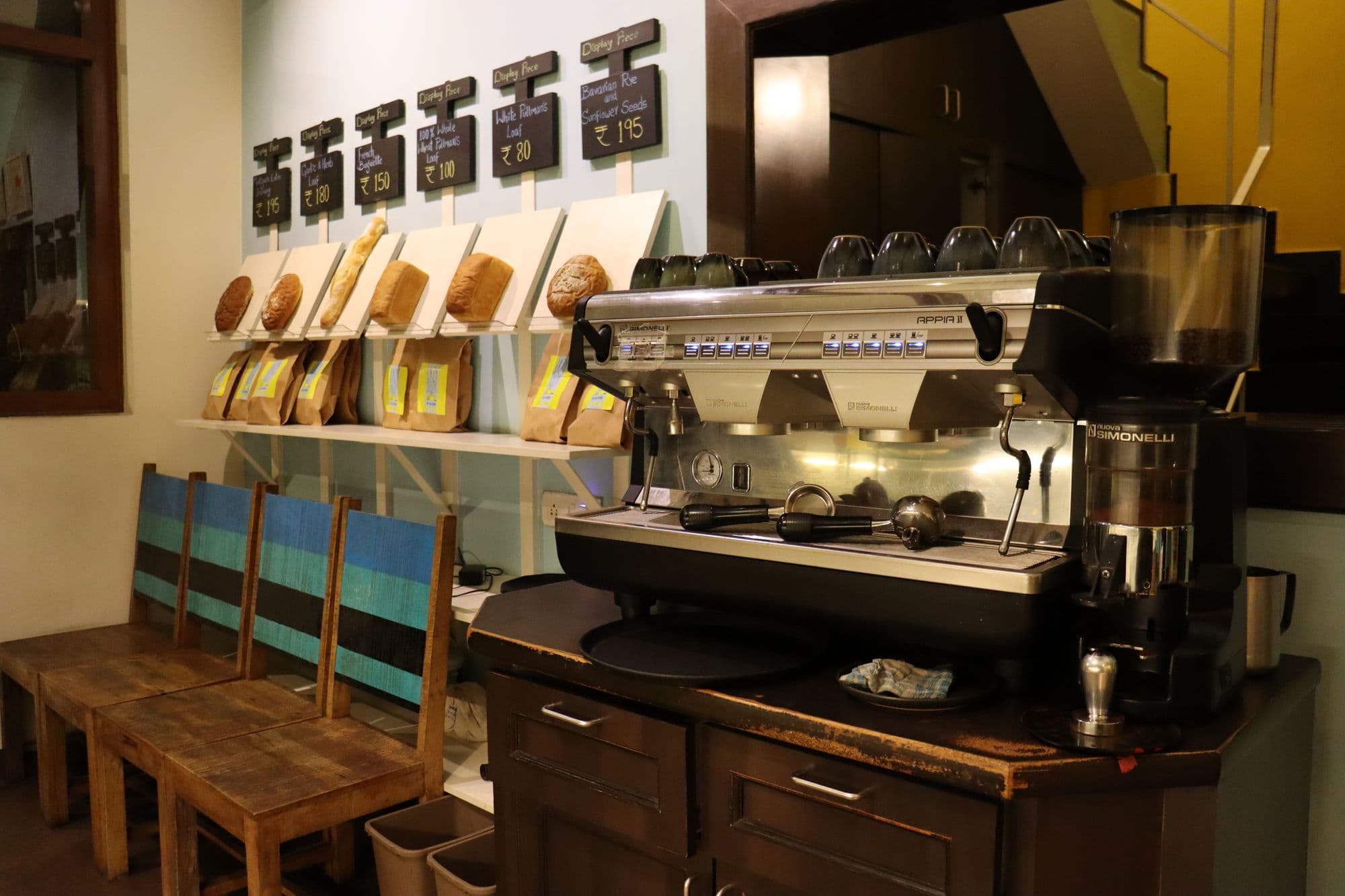 Interior de cafeteria com mesas, cadeiras e balcão de atendimento